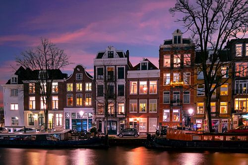 Amsterdam houses along the Amstel River in the Netherlands at night