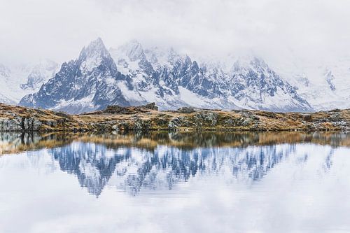 Reflection of snow-capped peaks in the lake