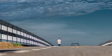 Bridge over A7 near Wons in Friesland with walking man and car by Harrie Muis