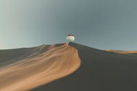 Glass ball on sand dune