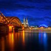 Cologne's Blue Hour: Bridge and Cathedral in Twilight by Bart Ros