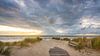Wolkenlucht bij de strandopgang van Petten aan Zee van Martijn van Dellen thumbnail