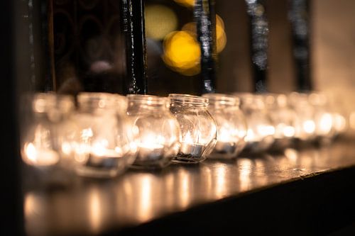 Atmospheric burning tea lights in a window