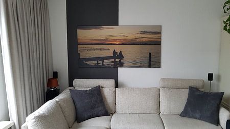 Sunset with people on jetty at Loosdrecht lakes