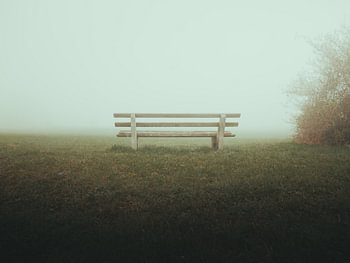 A lonely bench in the thick morning mist