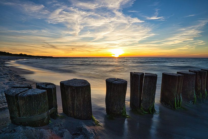 Groynes reaching into the Baltic Sea in a long exposure at sunset. by Martin Köbsch