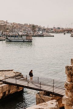 Man walks over coastal walkway at Sidon in Lebanon by Moniek Kuipers