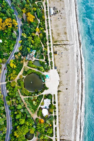 winding road among the green and yellow autumn forest. Aerial view from top to bottom of the turquoi by Michael Semenov