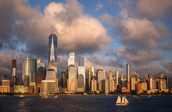 Lower Manhattan Skyline and moon rising at Golden Hour, NYC, USA