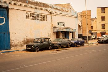 Three old abandoned cars