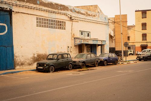 Three old abandoned cars