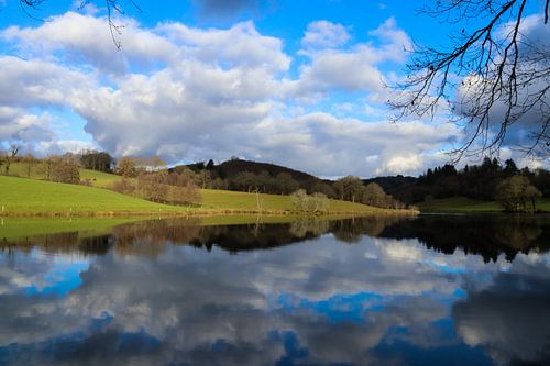 a reflection of the sky in the lake