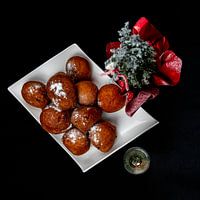flat lay of oliebollen with champagne decorated with a Christmas tree