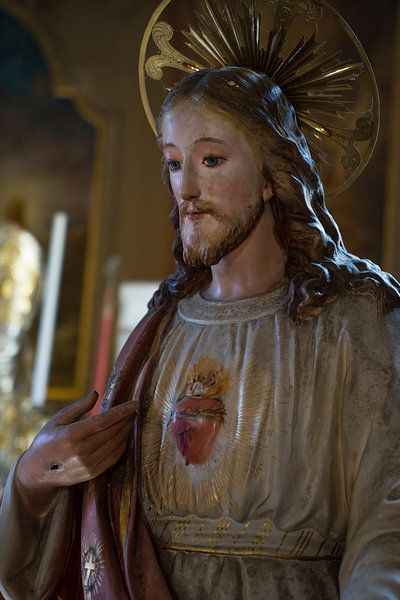 Wooden statue of Jesus Christ with Sacred Heart in church by Leoniek van der Vliet