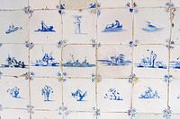 Een muur van historische Delfts blauwe tegeltjes