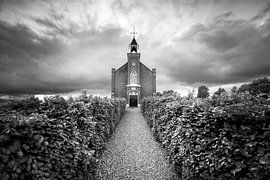 An old refuge church on a mound beneath a threatening, stormy sky