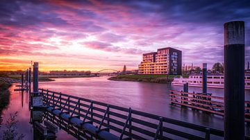 Overlooking Deventer and the pothead on the IJssel with colourful clouds in the sky by Bart Ros