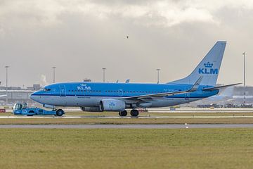KLM Boeing 737-700 is towed to hangar. by Jaap van den Berg