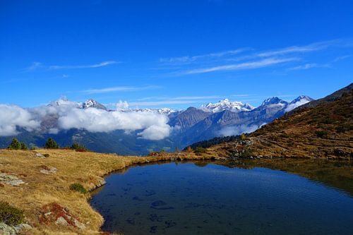 An alpine mountain lake with views of snow-capped peaks