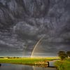 Regenboog boven de polder van Bas Meelker