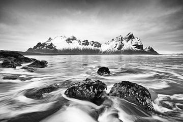 Mountain range in front of wild surf - black and white