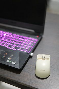 Modern Laptop with Rexus Mouse on Desk