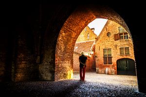 Old city gate with walker in Zutphen.