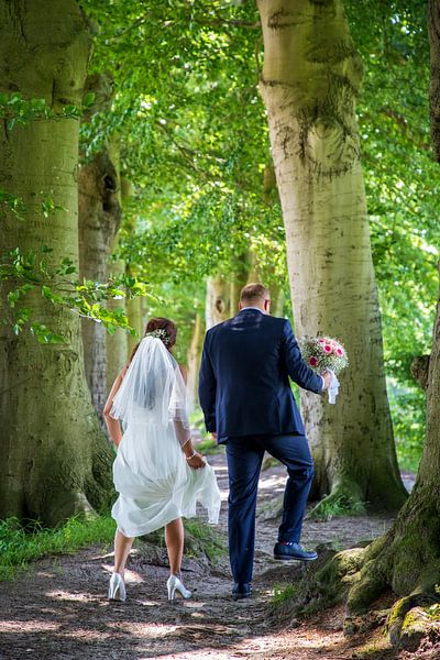 Bridal couple under the trees. by Ton Tolboom