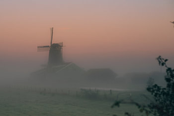 Sunrise over the polder mist