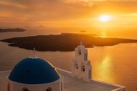 Church with blue dome at sunset on the island of Santorini in Greece