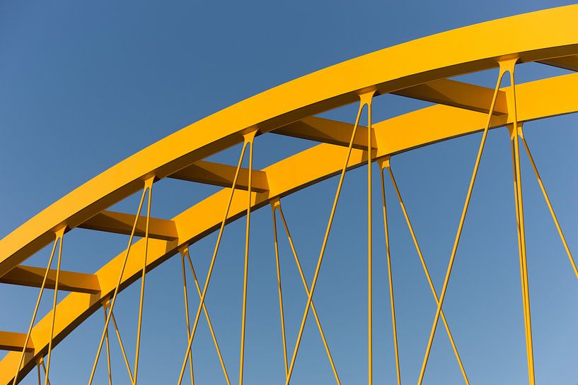 Gele stalen brug in Utrecht tegen een blauwe lucht van mike van schoonderwalt