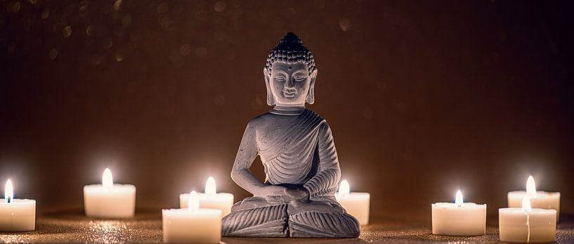 Meditating Buddha with candlelight by Alexander Baumann