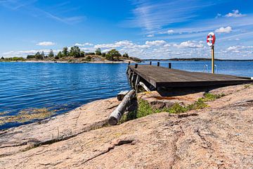 Baltic Sea coast with rocks and jetty on the island of Sladö in Sweden by Rico Ködder