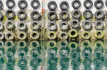 Car tires on the quay wall