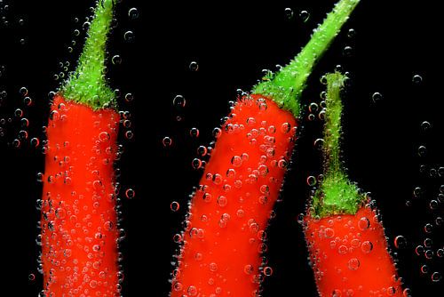 Red peppers under water