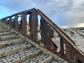Rusty railing on the beach by Benjamin Dickmann