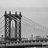 View of the Empire State Building framed by the Manhattan Bridge by Carlos Charlez