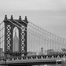 View of the Empire State Building framed by the Manhattan Bridge by Carlos Charlez