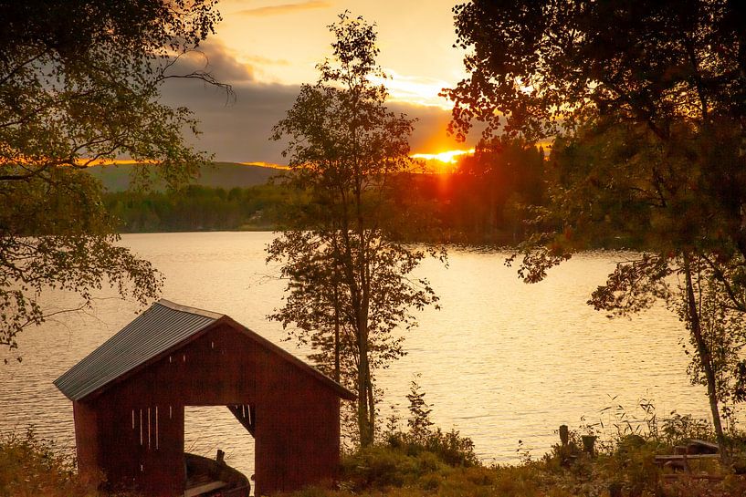 Altes Bootshaus mit Schaluppe auf dem schwedischen See bei Sonnenuntergang. von Maarten Visser