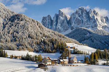 Kerk in de Alpen in de winter met sneeuw op de bergen