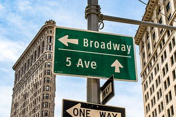 Street signs Broadway and 5th Avenue with Flatiron building in the background in Manhattan, New York by WorldWidePhotoWeb