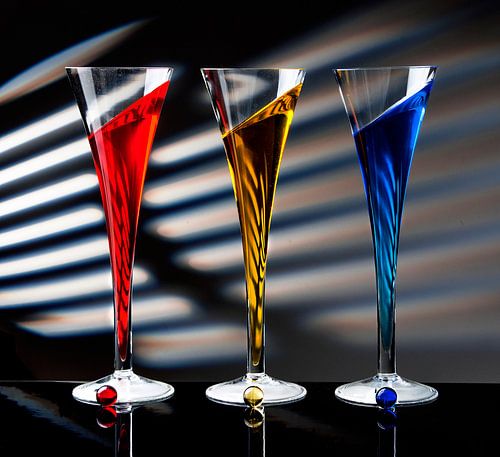 Champagne glasses: red, yellow and blue.