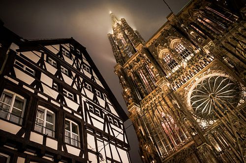 Strasbourg Cathedral and old half-timbered house by night
