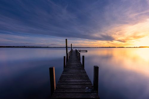 Beautiful sunset with clouds over a jetty