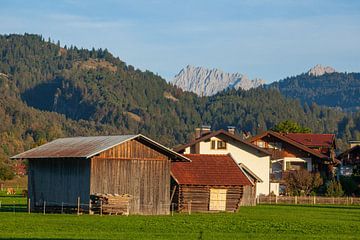 Hooischuur met weide en Alpen in het avondlicht