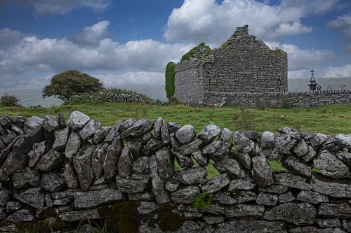 Church ruin with cemetery and stone wall. Ireland
