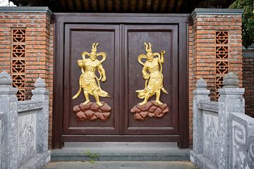 Portal decorated with golden protective divinities by Frank Photos