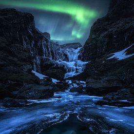 Frozen waterfall on aurora borealis night in Iceland by Daniel Gastager