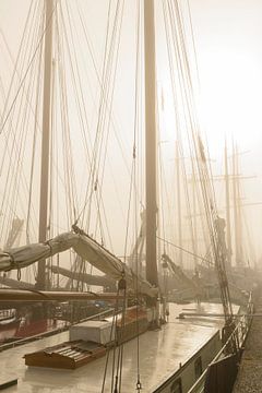 Old traditional sailing ships moored during a foggy morning by Sjoerd van der Wal Photography