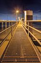 Illuminated pier on large metal mooring posts by Tony Vingerhoets thumbnail